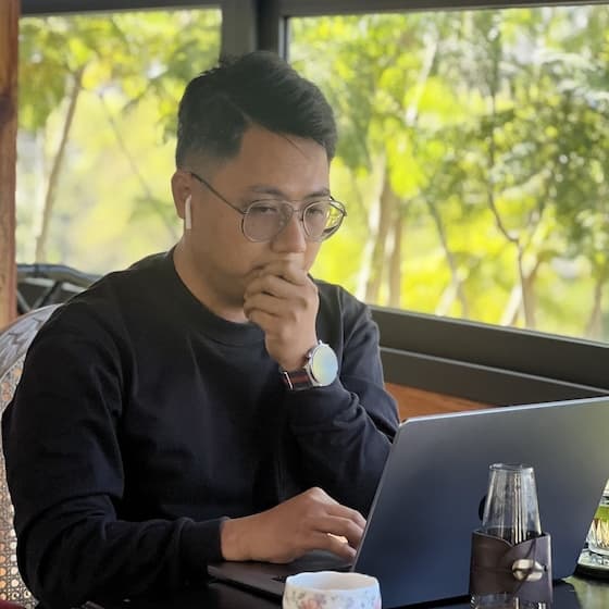 Dinh working on his laptop